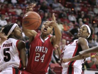 UNLV center Shamela Hampton reaches for a rebound between San Diego State guard Jene Morris, left, and forward Jen Layton-Bailes during the semifinal game at the Mountain West Conference Basketball Championships Friday, March 13, 2009.  San Diego State won the game 71-63. 