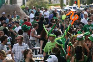 Party-goes enjoy the atmosphere during a St Patrick's Day block party outside O'Sheas on the Strip.
