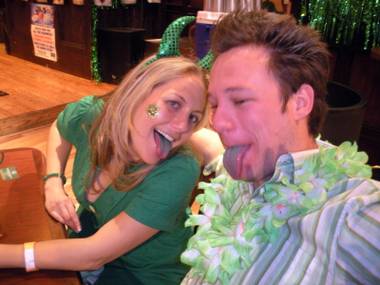 Las Vegas residents Jeanne Slingluff and Brian Evans show off their green-tinted tongues while celebrating St. Patrick’s Day with green beer specials at McFadden’s Tuesday.