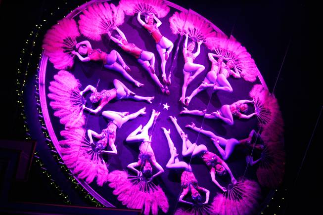 The showgirls are reflected in a mirror during a performance ...