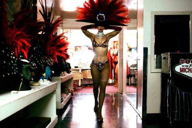 Showgirl Svetlana Failla secures her headdress before going onstage for ...