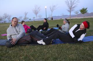 Members of the Boulder City Bootcamp execute medicine ball sit-ups and torso twists Monday morning at Veterans Memorial Park. Clockwise from left: Mike Prahm, Cathy Domzalski, Krista Rendon, Nikki Wendt and Pam Heilman.