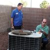 
Technician Rich Parker, left, and Jack Ramsay of Sierra Air Conditioning check out a unit at a house involved in a lawsuit. Ramsay is there because he received notice from the builder, which had received a letter from the homeowner's attorney complaining of problems.