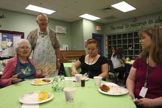 Fifth-grade teacher Karen Hughes, right, and instructional assistant Kayla Vucekovich enjoy an omlette breakfast with Neil Twitchell and his wife, Wanda, left, Tuesday morning at Neil C. Twitchell Elementary School.