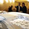 Andrew Mack, center, chief operating officer of DesertXpress Enterprises, talks to a reporter behind a model of a proposed Victorville station is displayed during a news conference for the DesertXpress high-speed rail project Thursday, March 25, 2010.