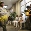 Dressed as a lemon while representing Pulte and Del Webb homeowners and union members, Ben Horowitz, left, stands with Norma Uribe outside the council chambers of the Nevada State Contractors Board waiting to present the National Lemon Award to the board during the Thursday morning meeting.