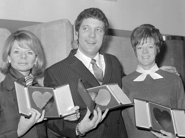 British singer Tom Jones holds an inscribed silver heart award ...