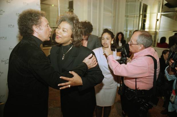 Singer Tom Jones, far left, gives rap artist Queen Latifah ...