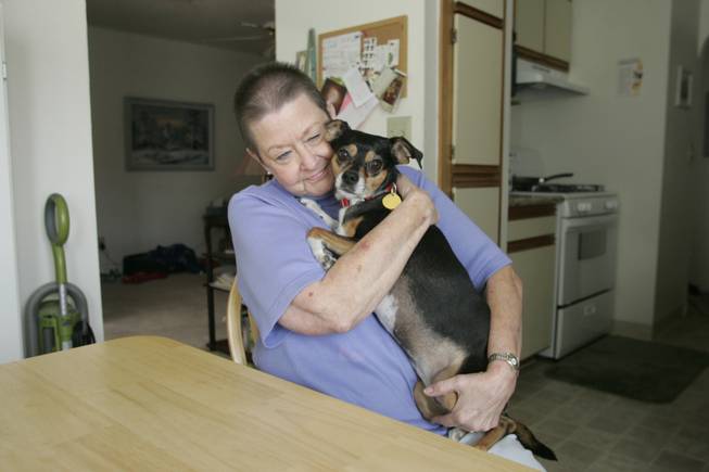 Raye Kraft, at home with her dog Moxie, said she watched Drs. Dhiresh Joshi and Fadi El Salibi write notes in her now-deceased husband's medical records documenting examinations that she says, based on her observations and notes, they never performed.
