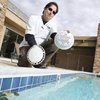 Mike Heiney, owner of Westside pools, compares an old pool drain cover, left, with a new anti-entrapment cover designed to prevent death. Federal law requires that public and community pools and spas have the drain covers installed, which Heiney calls "an expensive process."