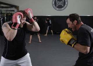 MMA fighter Roy Nelson, left, makes a face at R.J. Richter on Monday during a drill at Gold's Gym in Summerlin.