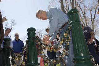 Senate Majority Leader Harry Reid (D-Nev.) attaches a lock to a chain during a campaign stop in Lovelock, Nev., Wednesday, April 7, 2010. The practice is borrowed from a Chinese tradition where locks with the names of couples are locked onto a chain to ensure everlasting love. 