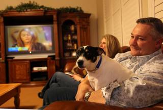 North Las Vegas mayoral candidate Shari Buck, her husband, Keith, and their dog, Benny, wait for results in the municipal primary election Tuesday at their home.