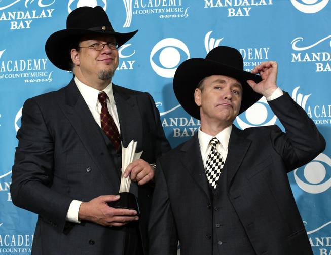 Penn Jillette, left, and Teller pose backstage at the 39th annual Academy of Country Music Awards in Las Vegas, in this May 26, 2004, file photo. 