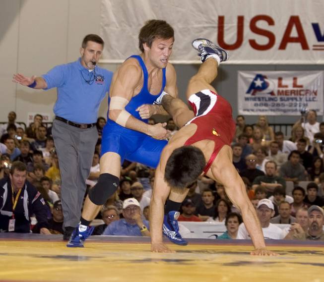 Former Eldorado High wrestler Matt Azevedo, left, takes down Henry Cejudo during the 121.5 freestyle finals  at last year's USA National Wrestling Championships. Azevedo, who is pondering retirement, will not compete in this week's Nationals.