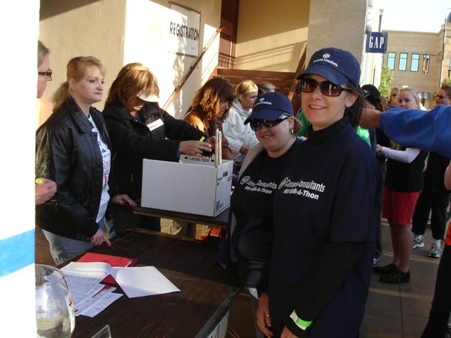 From right, former Converse Consultants employee Cindy Bell and current employee Jill Cuevas register for the 2009 WALK MS event at Town Square. 