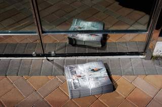 A bundle of new magazines sits outside Adam's Ribs, which is apparently closed for business at their Summerlin location Thursday, April 9, 2009. 