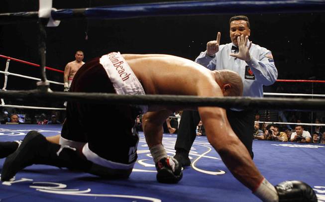 Referee Tony Weeks counts out Jameel McCline after he was knocked out in the fourth round by Chris Arreola during a heavyweight fight at the Mandalay Bay Events Center in Las Vegas, Nevada, April 11, 2009.