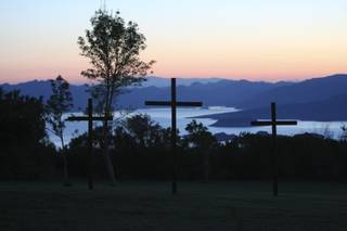 Three crosses representing the crucifixion of Christ stand silhouetted in the morning sunrise during the 22nd Annual Easter Sunrise service overlooking Lake Mead Sunday at Hemenway Park in Boulder City.