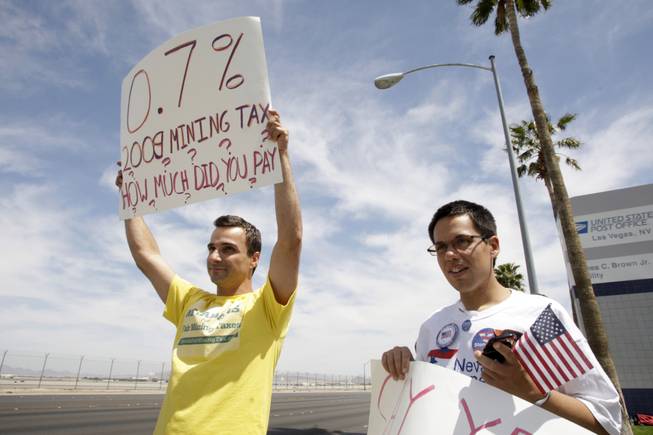 Michael Ginsburg, left, a member of the Progressive Leadership Alliance of Nevada, and Andrew Davey, web director for Stonewall Democratic Club of Southern Nevada, picket in front of the main post office on Sunset Road Thursday, April 15, 2010. About a dozen protesters came out to support the services that taxes provide and to demand greater "tax fairness," such as an increase in mining taxes and a implementation of a broad-based business tax.