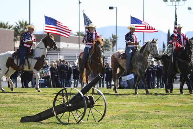 The Brown family cross the battlefield on horses to begin the flag ceremony for Martha P. King Elementary's annual fifth-grade Civil War reenactment Friday at Boulder City High School.
