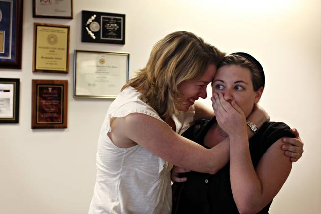 Reporter Emily Richmond, left, embraces reporter Alexandra Berzon as she ...