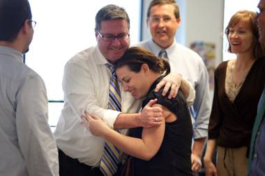 Reporter Joe Brown embraces reporter Alexandra Berzon as she returns to the newsroom and learns of the Las Vegas Sun’s win of the Pulitzer Prize for public service for exposing a high death rate among construction workers on the Las Vegas Strip, at the Las Vegas Sun offices in Henderson, Nevada on Monday, April 20,&nbsp;2009. 