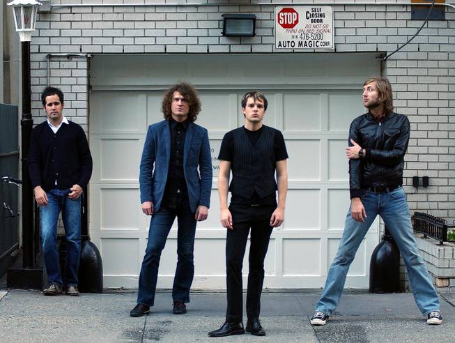 In this Oct. 4, 2004 file photo, Las Vegas-based group The Killers pose for a photo in New York.  From left, Ronnie Vannucci, Dave Keuning, Brandon Flowers and Mark Stoermer. 