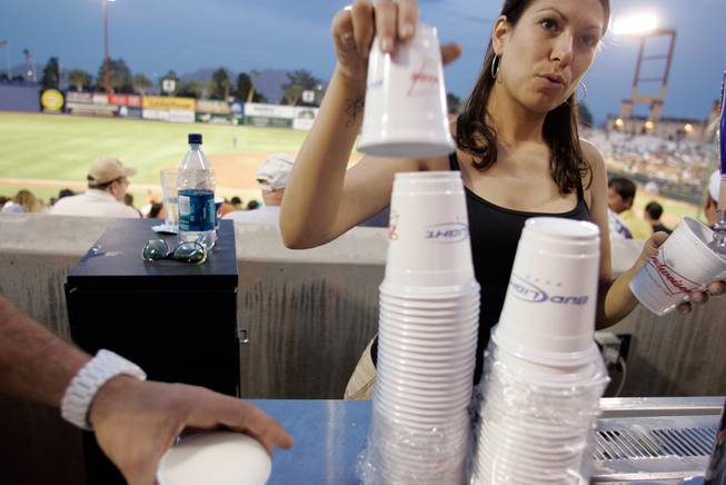 Bartender Casey Stuper serves up cold ones during Dollar Beer Night at the Las Vegas 51s game at Cashman Field Thursday, April 23, 2009.
