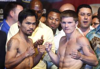 Junior welterweight boxers Manny Pacquiao, left, of the Philippines and Ricky Hatton of Britain pose during an official weigh-in at the MGM Grand Garden Arena in Las Vegas, Nevada May 1, 2009. The boxers will meet for a 12-round title bout at the arena Saturday.