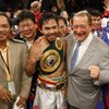 Manny Pacquiao poses after his second round knockout of Ricky Hatton at the MGM Grand Garden Arena in Las Vegas on May 2, 2009. With Pacquio are boxing promoter Bob Arum, second from right, and head trainer Freddie Roach, far right.