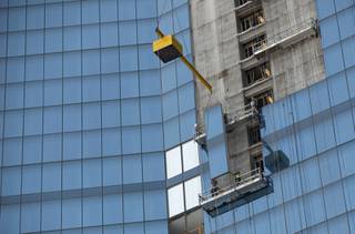 Employees of Z Glass install the glass panels that make up the exterior of the Fontainebleau hotel and casino.