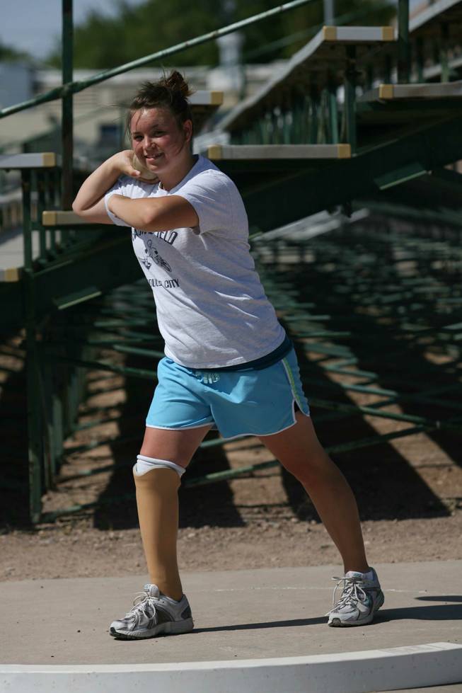 Boulder City High freshman Danyell Harding practices the shot put last week. Harding, who had her right leg amputated below the knee as an infant, wears a prosthetic limb. She competed in the shot put and discus this spring.