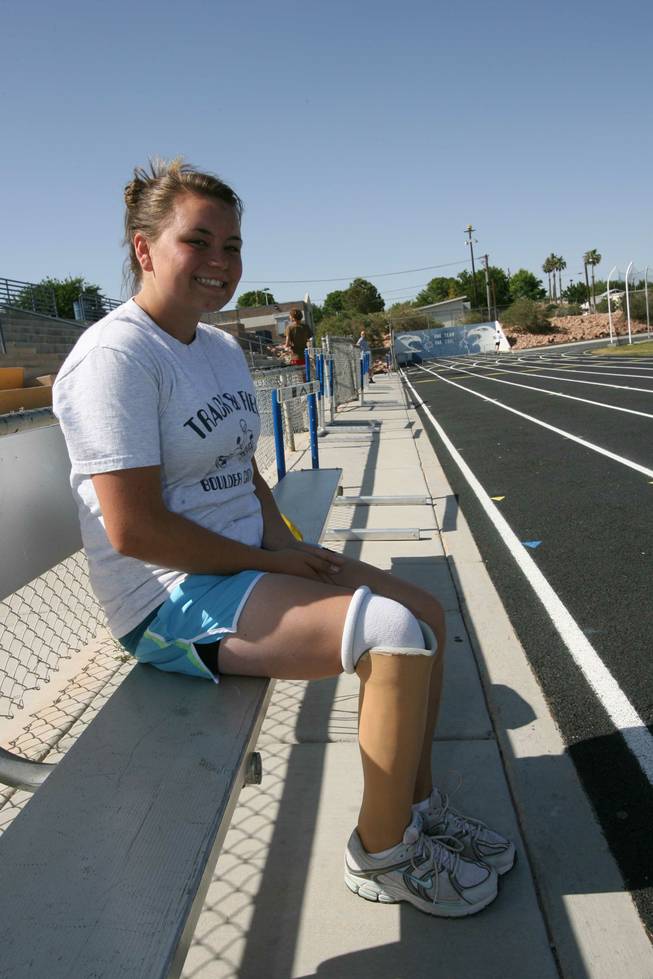 Boulder City High freshman Danyell Harding poses for a photo last week at the school's track. Harding, who competes in the the discus and shot put for the Eagles, had her right leg amputated below the knee as an infant. 