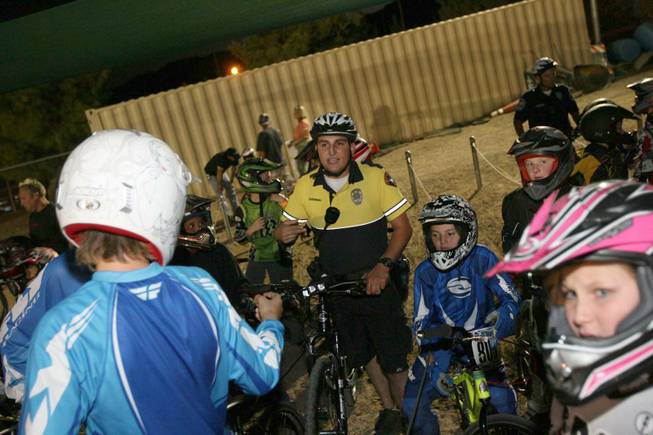 Boulder City officer Anthony Guerrero talks with young cyclist during BMX Is Not A Crime at the BMX track at Veterans Memorial Park.