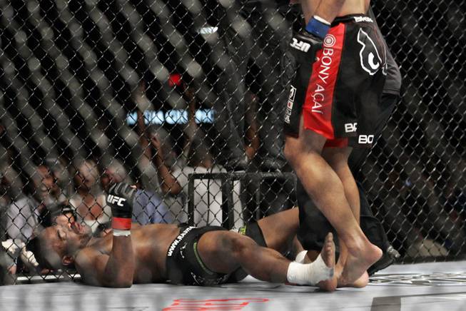 Rashad Evans, left, lays sprawled out in the Octagon as Lyoto Machida dropped him in the second round of their title fight at UFC 98 at the MGM Grand Saturday, May 23, 2009.