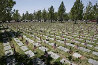 American Flags mark grave stones at a Memorial Day program held in remembrance of those who served in the U.S. military at the Southern Nevada Veterans Memorial Cemetery in Boulder City Monday, May 25.