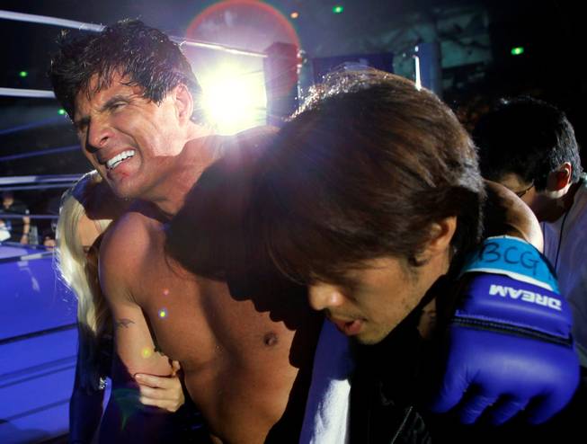 Former major league MVP player Jose Canseco leaves the ring after losing his debut match against super heavyweight Hong Man Choi of South Korea in the mixed martial arts Dream 9 card at Yokohama Arena in Yokohama, Japan, Tuesday, May 26, 2009. Hong beat Canseco with a knockout in the first round.