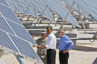 President Barack Obama, accompanied by Senate Majority Leader Harry Reid and Col. Howard Belote, looks at solar panels at Nellis Air Force Base in Nevada on Wednesday. 