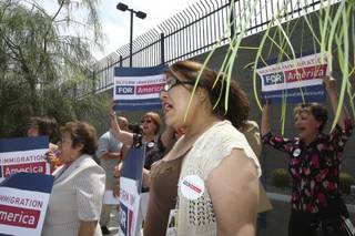 Rosa Acevedo, center, cheers with other supporters during a press conference launching the national Reform Immigration for America campaign Monday outside the Lloyd George Federal Building in Las Vegas.