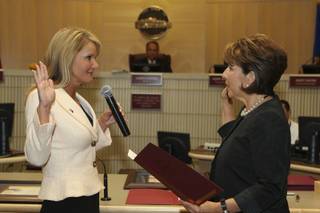 City Clerk Monica Simmons administers the oath of office to Councilwoman Kathleen Boutin, left, Tuesday during a swearing-in ceremony at the Henderson City Council meeting.