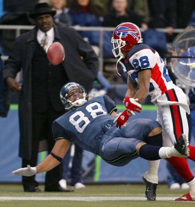 Seattle's Itula Mili (88) falls back while missing a pass with Buffalo Bills' Kevin Thomas defending during the third quarter in Seattle on Sunday, Nov. 28, 2004. The Bills won 38-9.