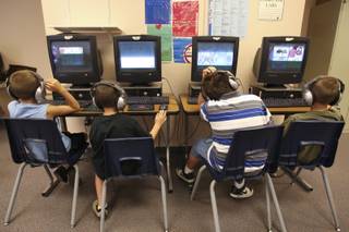 First- through third-grade students concentrate on educational computer games tailored for their individual reading and language skills during the summer Fast ForWord Program June 17 at Martha P. King Elementary School.