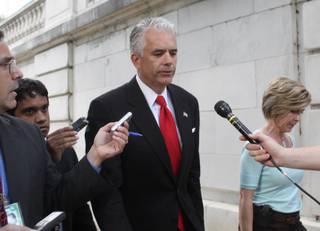 Sen. John Ensign, R-Nev., is seen talking with reporters on his way to a vote on Monday, June 22, on Capitol Hill in Washington.