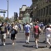 Tourists stroll along Las Vegas Boulevard in front of Paris Las Vegas.