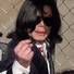 Singer Michael Jackson gestures to cameras as he leaves the Santa Maria courthouse on Jan. 16, 2004, in Santa Maria, Calif. Jackson appeared in court for his arraignment on charges of child molestation.