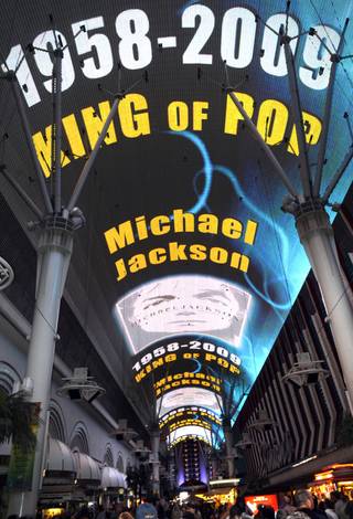 A video tribute to fallen pop icon Michael Jackson plays across the canopy of the Fremont Street Experience on Thursday night.