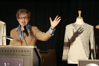 Kathleen Guzman calls for bids next to a shirt worn by Michael Jackson on his 