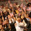 Newly sworn in U.S. citizens wave flags Thursday. U.S. Citizen and Immigration Services and the city of Las Vegas welcomed more than 100 Las Vegas-area residents as new citizens during a Thursday swearing-in ceremony at Las Vegas City Hall.
