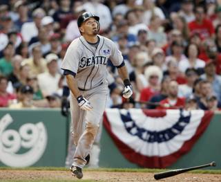Seattle Mariners' Chris Woodward watches his game winning bloop RBI single during the ninth inning of their 3-2 win over the Boston Red Sox in a baseball game at Fenway Park in Boston Saturday, July 4, 2009. 